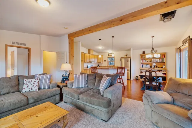 a living room with furniture and kitchen view