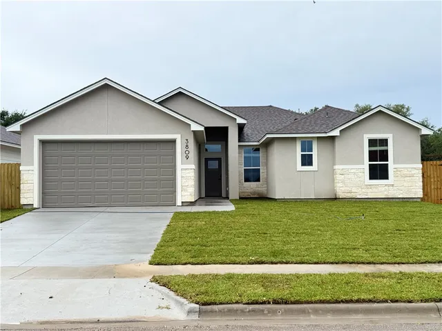 a view of a house with a yard and garage