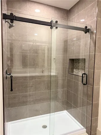 a bathroom with a shower and a sink