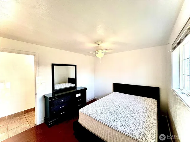 a bedroom with a bed and a dresser