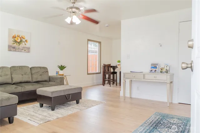 a view of a dining room with furniture and a potted plant
