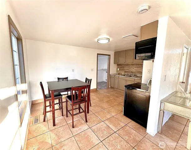 a dining room with furniture and wooden floor