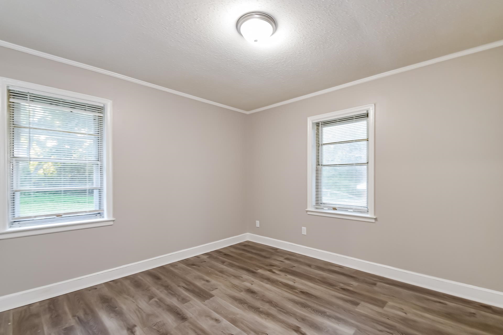 5041 Davis Cove Memphis, TN 38116 - Photo 12 of 16 an empty room with wooden floor and windows