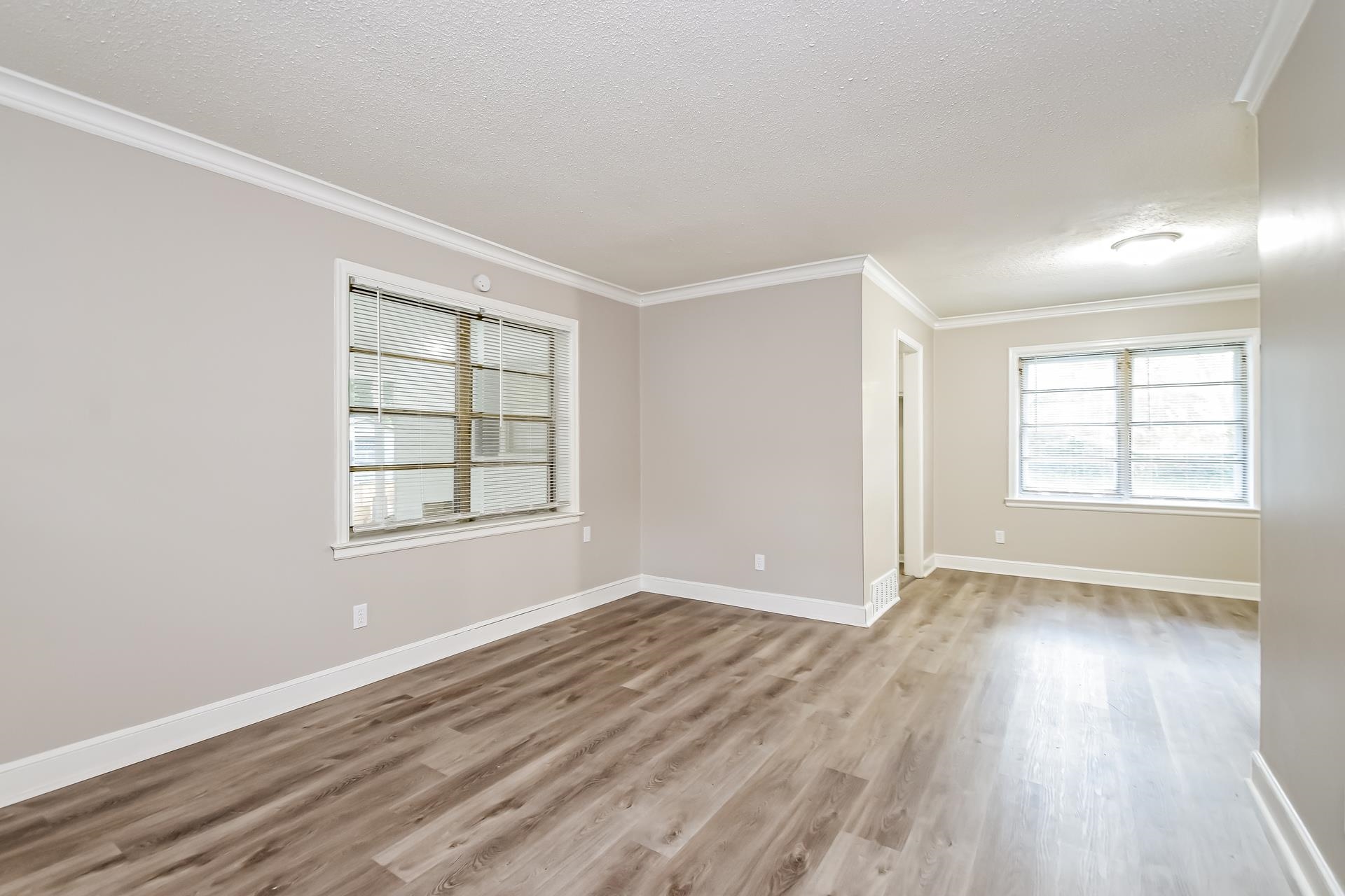 5041 Davis Cove Memphis, TN 38116 - Photo 3 of 16 an empty room with wooden floor and windows