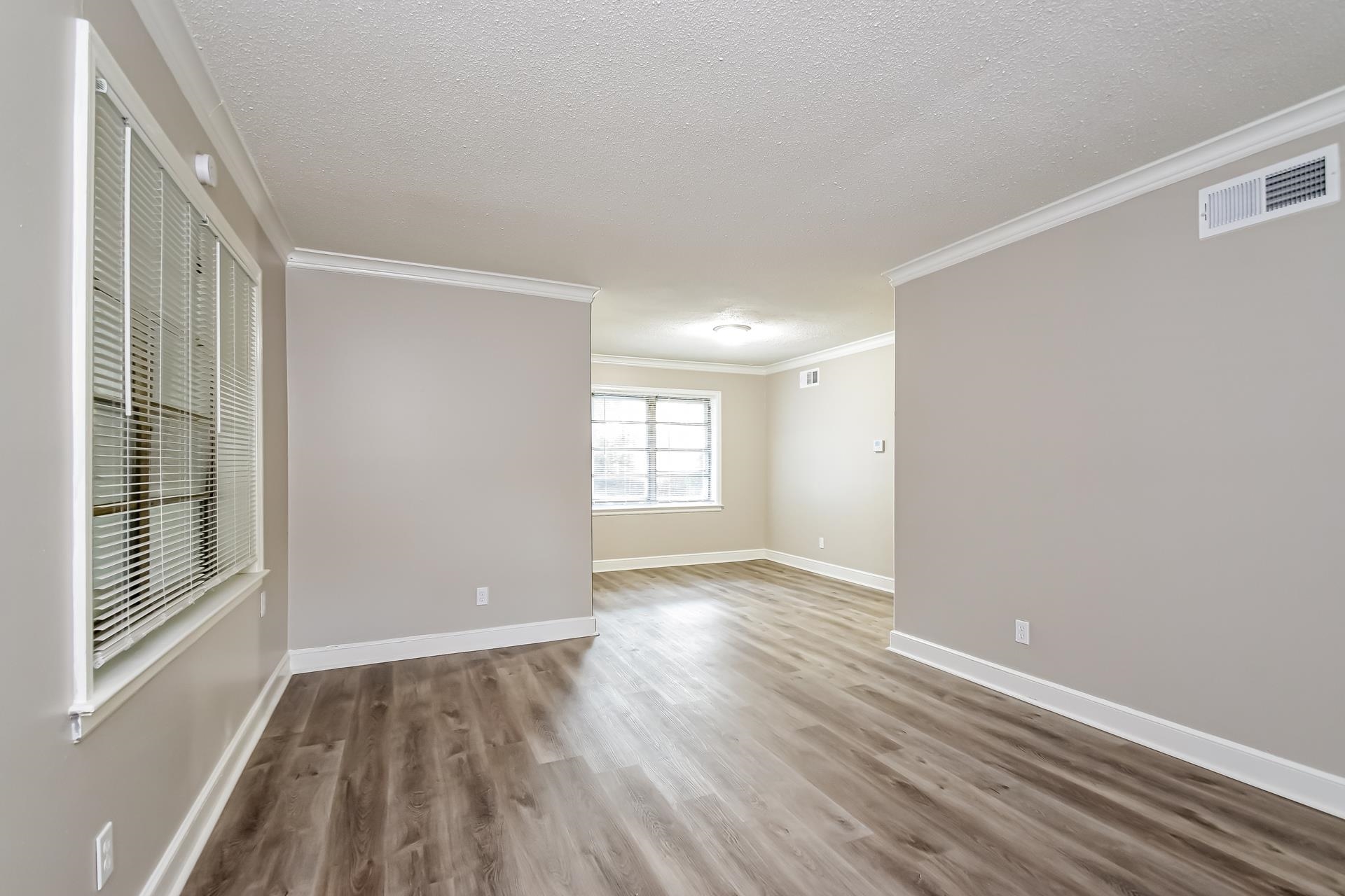 5041 Davis Cove Memphis, TN 38116 - Photo 4 of 16 a view of an empty room with wooden floor and a window