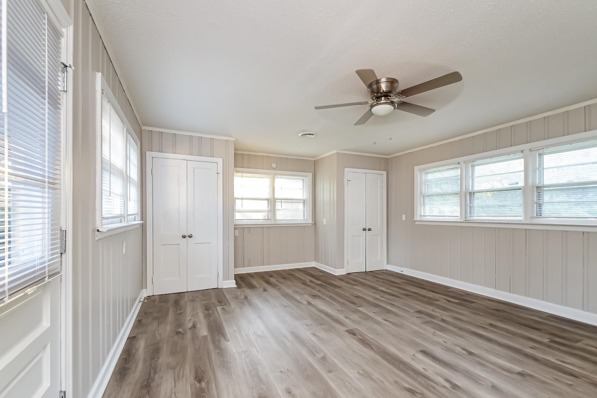 5041 Davis Cove Memphis, TN 38116 - Photo 9 of 16 a view of a room with window ceiling fan and hardwood floor