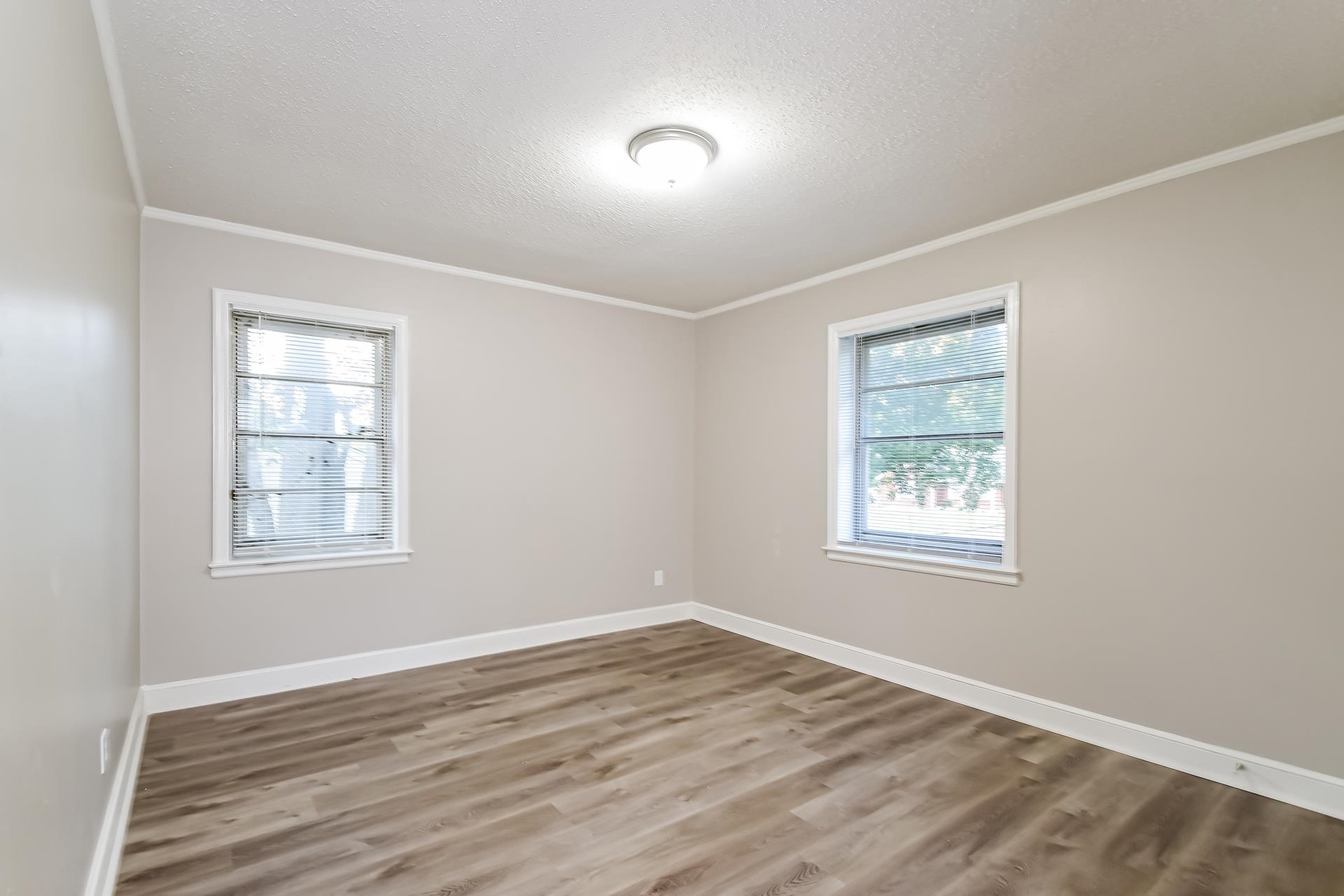 5041 Davis Cove Memphis, TN 38116 - Photo 10 of 16 an empty room with wooden floor and windows
