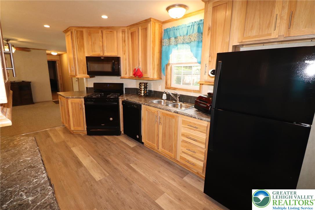 5005 Old Timber Road Stroudsburg, PA 18360 - Photo 11 of 44 a kitchen with stainless steel appliances granite countertop a refrigerator a stove a sink and a microwave