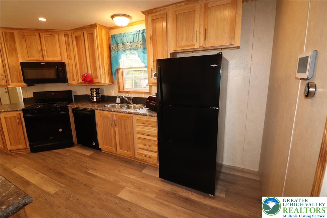 5005 Old Timber Road Stroudsburg, PA 18360 - Photo 12 of 44 a kitchen with a refrigerator and a stove