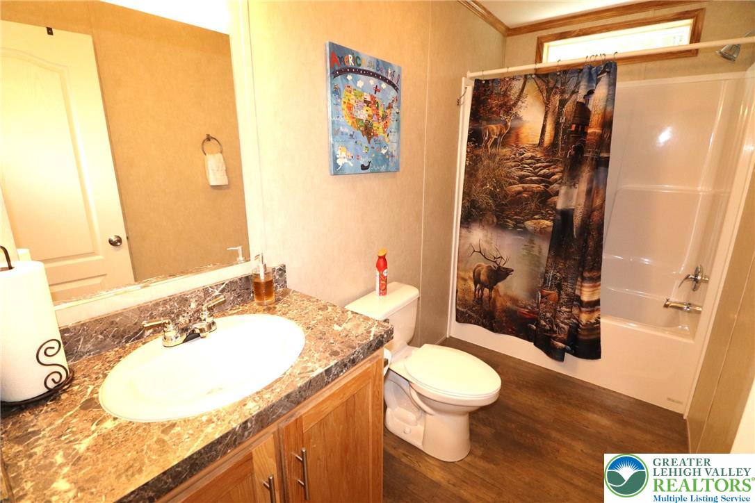 5005 Old Timber Road Stroudsburg, PA 18360 - Photo 18 of 44 a bathroom with a granite countertop sink and a mirror