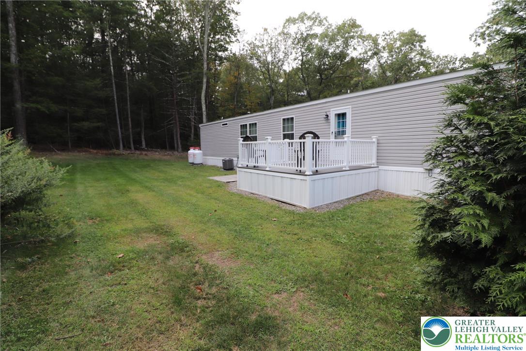 5005 Old Timber Road Stroudsburg, PA 18360 - Photo 34 of 44 a view of a house with a yard and sitting area
