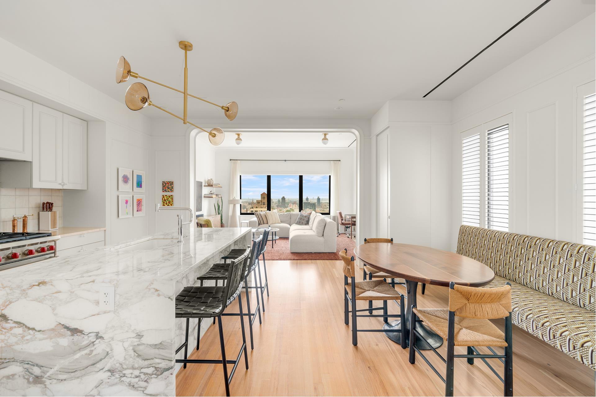 1 Prospect Park West, Unit PHF Brooklyn, NY 10035 - Photo 2 of 21 a view of a dining room and livingroom with furniture wooden floor a rug a flat screen tv a painting and a chandelier