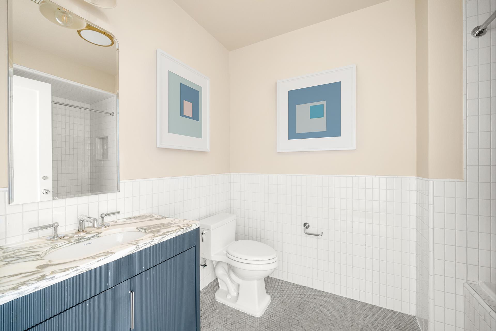 1 Prospect Park West, Unit PHF Brooklyn, NY 10035 - Photo 9 of 21 a bathroom with a toilet a sink and mirror