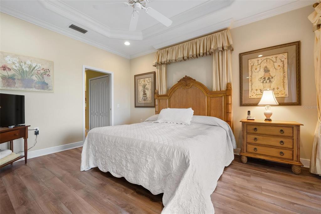 1807 San Trovaso Way Venice, FL 34285 - Photo 20 of 61 a bedroom with a bed and a flat tv screen on dresser