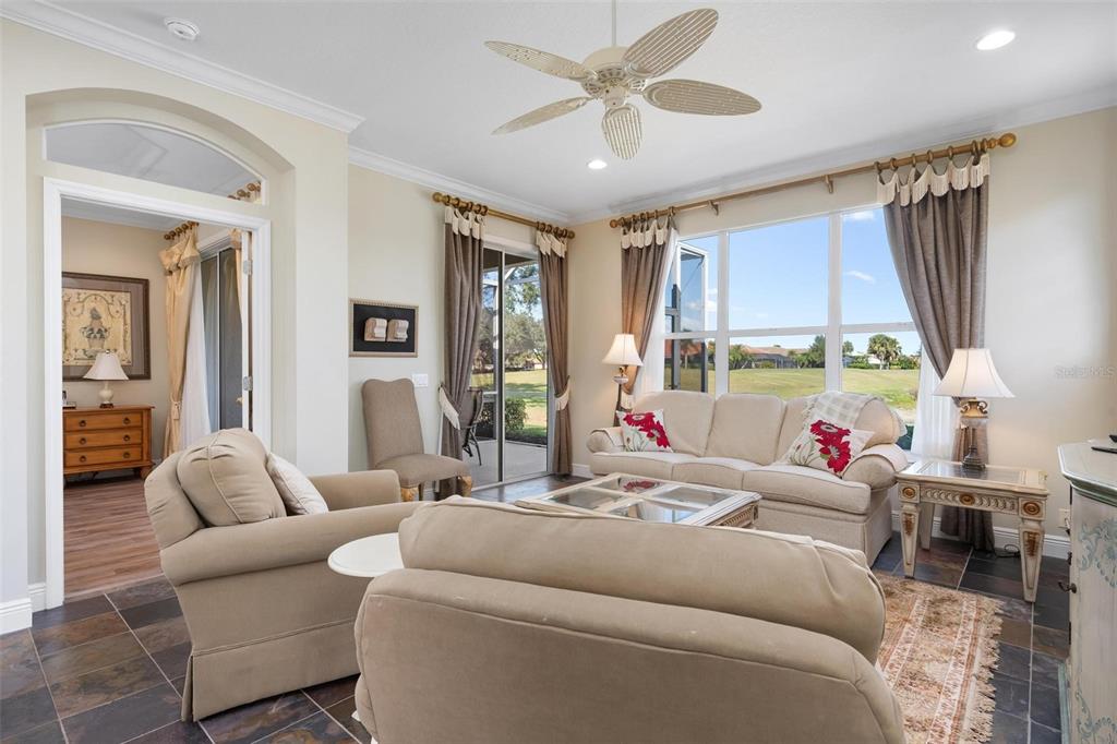 1807 San Trovaso Way Venice, FL 34285 - Photo 7 of 61 a living room with furniture fireplace and a large window