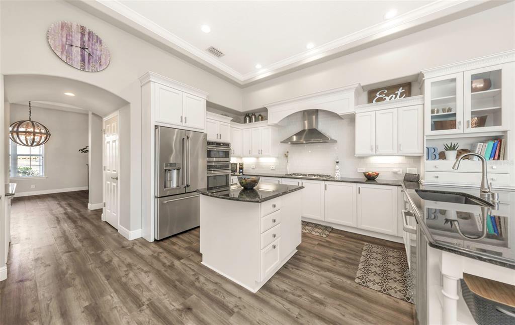 3716 Janus Way Palm Harbor, FL 34685 - Photo 11 of 69 a kitchen with stainless steel appliances granite countertop a refrigerator and a stove top oven