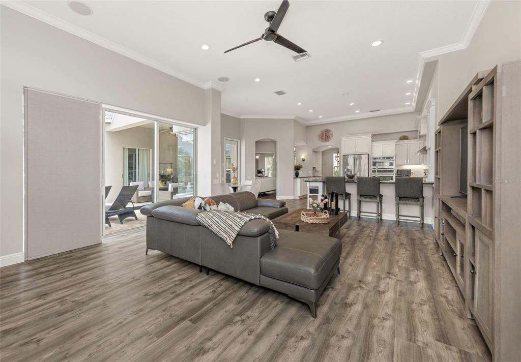3716 Janus Way Palm Harbor, FL 34685 - Photo 19 of 69 a living room with furniture and a wooden floor
