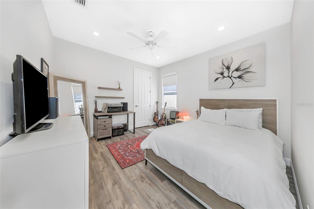 3716 Janus Way Palm Harbor, FL 34685 - Photo 29 of 69 a spacious bedroom with a bed and a flat screen tv