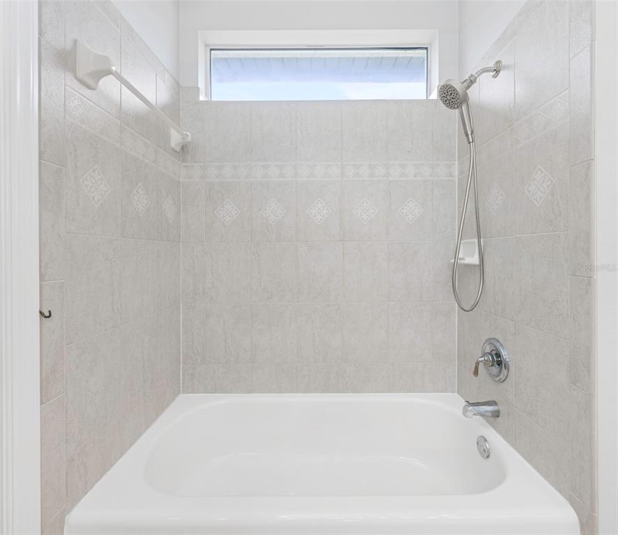 3716 Janus Way Palm Harbor, FL 34685 - Photo 35 of 69 a bathroom with a bath tub with a shower