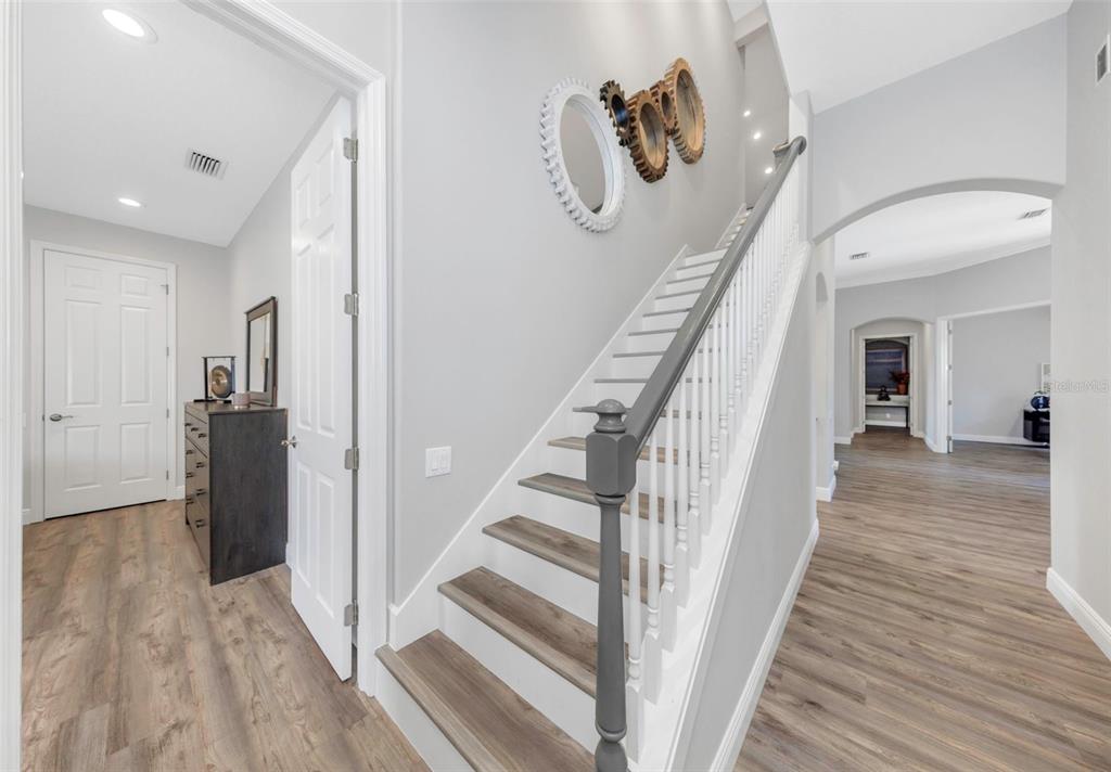 3716 Janus Way Palm Harbor, FL 34685 - Photo 38 of 69 a view of a hallway with wooden floor and staircase