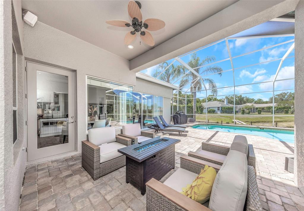 3716 Janus Way Palm Harbor, FL 34685 - Photo 46 of 69 a living room with patio furniture and a floor to ceiling window