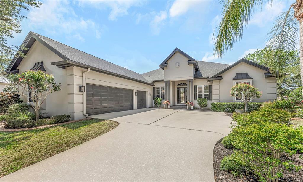 3716 Janus Way Palm Harbor, FL 34685 - Photo 64 of 69 a front view of a house with a garden and trees
