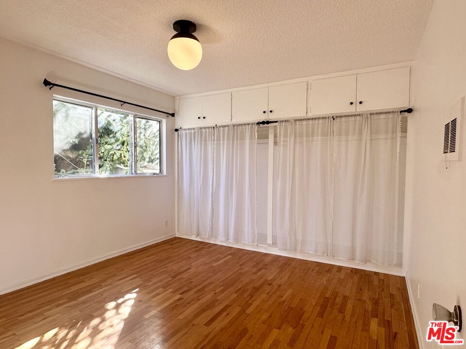 1420 17th Street, Unit 3 Santa Monica, CA 90404 - Photo 13 of 14 a view of a room with wooden floor and fan