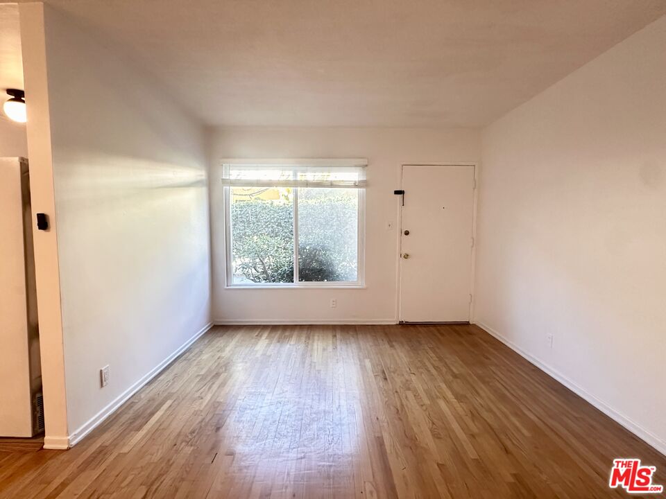1420 17th Street, Unit 3 Santa Monica, CA 90404 - Photo 5 of 14 an empty room with wooden floor and windows