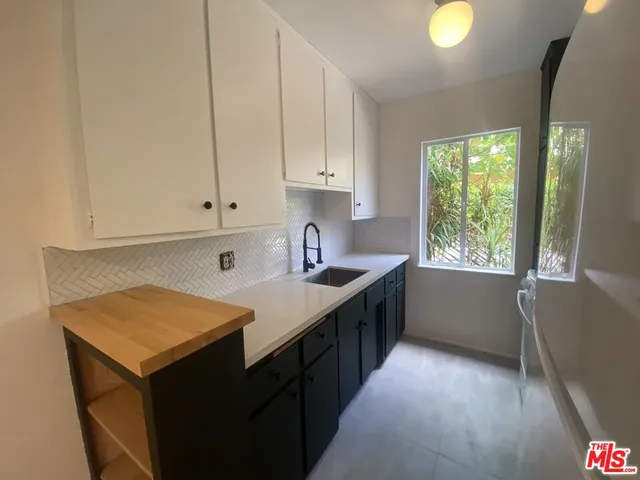 a kitchen with a sink stove and cabinets