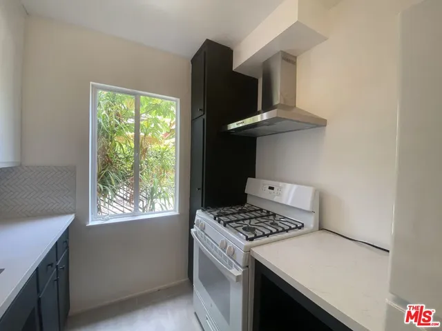 a kitchen with a stove and a refrigerator