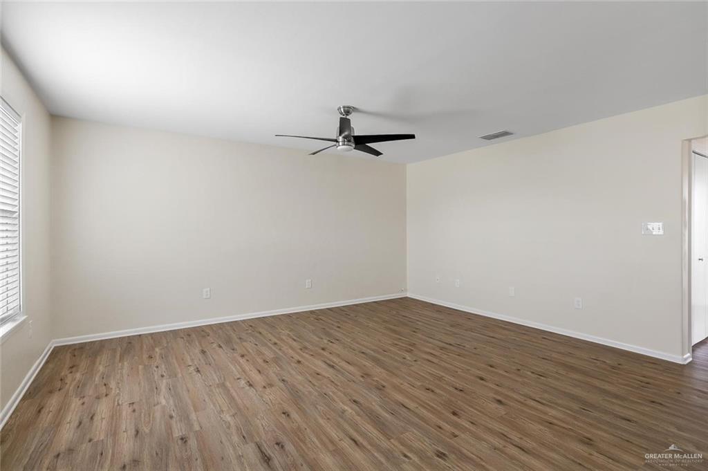 1105 West Stubbs Street, Unit 3 Edinburg, TX 78539 - Photo 3 of 15 a view of a room with wooden floor and a ceiling fan
