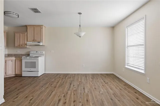 a view of kitchen and wooden floor
