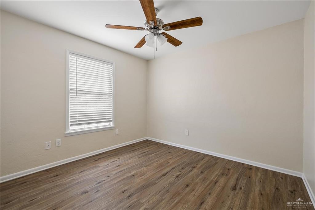 1105 West Stubbs Street, Unit 3 Edinburg, TX 78539 - Photo 8 of 15 wooden floor in an empty room with a window