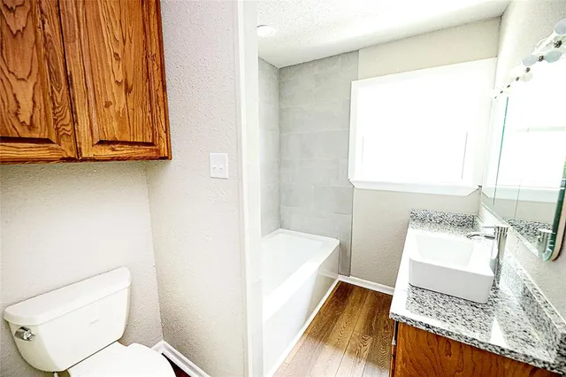 a bathroom with a sink vanity granite and a mirror