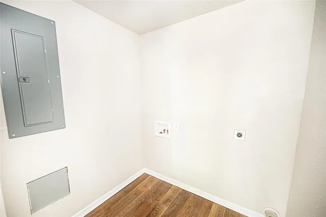 a view of empty room with cabinet and window