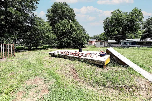 a view of a swimming pool with a yard