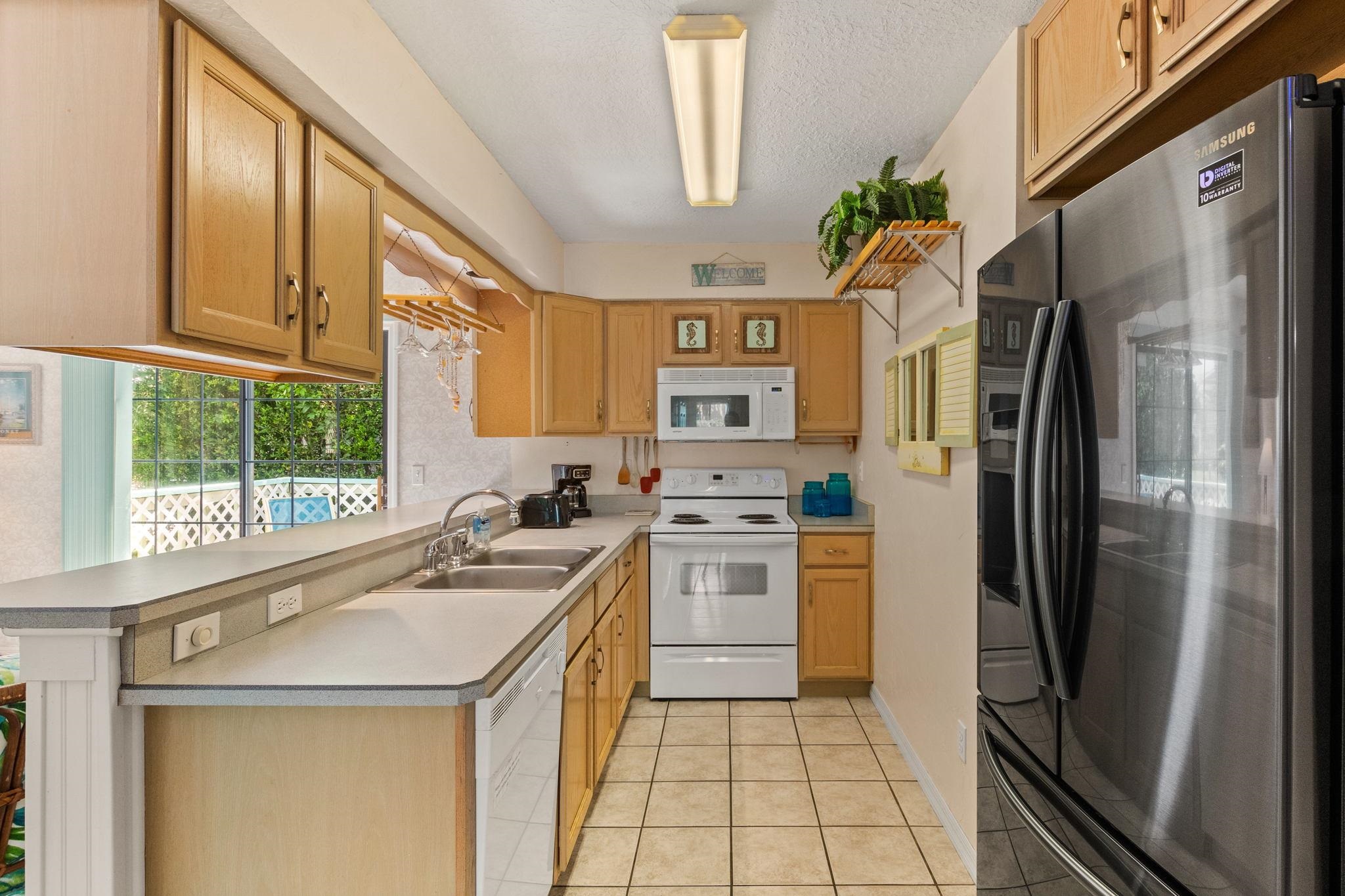 11 C Street St. Augustine, FL 32080 - Photo 14 of 40 a kitchen with stainless steel appliances a refrigerator sink and stove