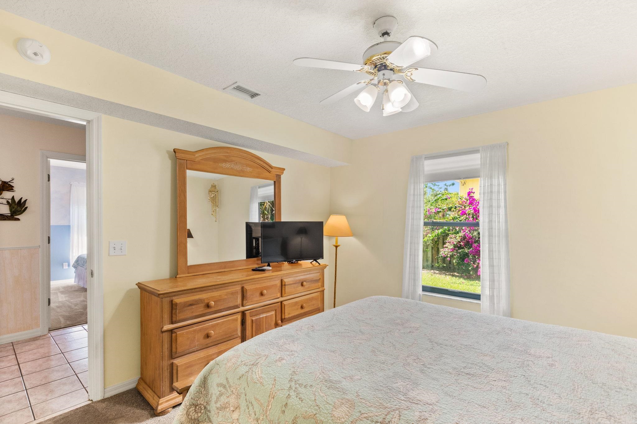 11 C Street St. Augustine, FL 32080 - Photo 18 of 40 a bedroom with a bed and a chandelier