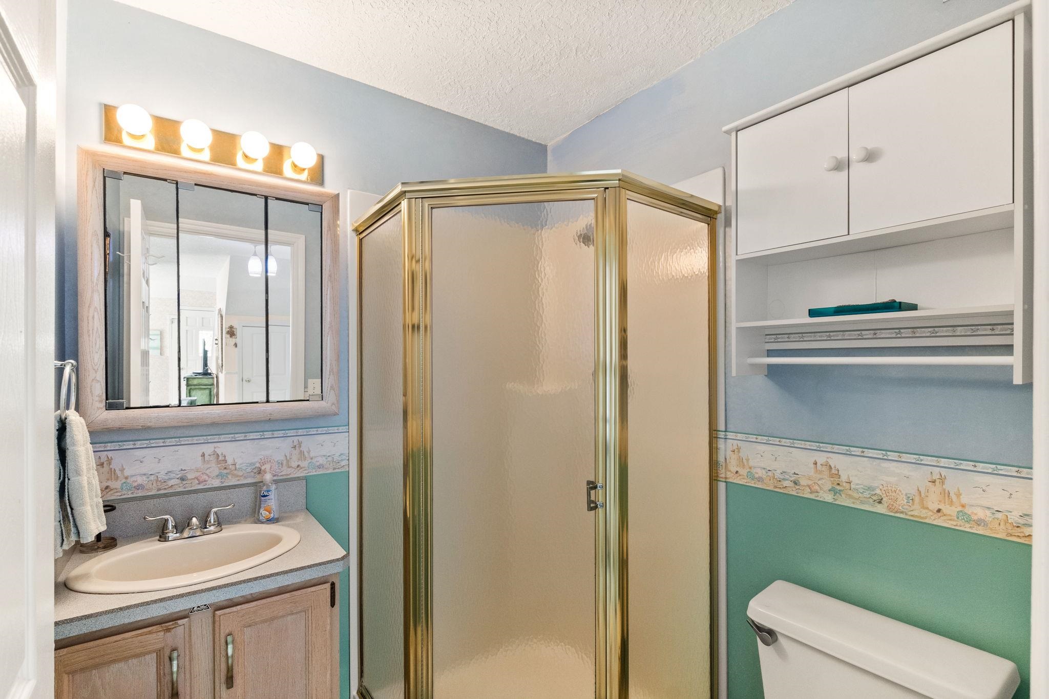 11 C Street St. Augustine, FL 32080 - Photo 21 of 40 a bathroom with a sink a toilet and a mirror