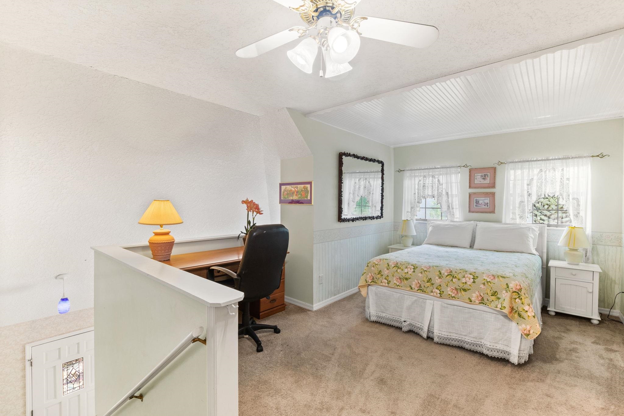 11 C Street St. Augustine, FL 32080 - Photo 25 of 40 a bedroom with a bed and a chandelier