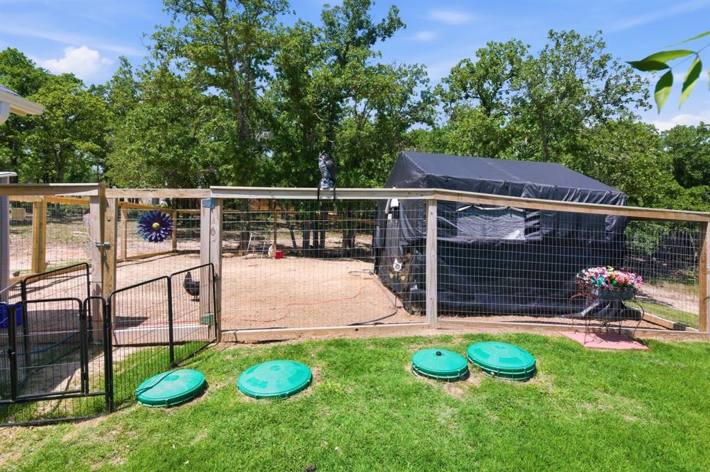112 Monarch Lane Poolville, TX 76487 - Photo 29 of 37 Fenced enclosure featuring wood posts, wire mesh panels, and a gate