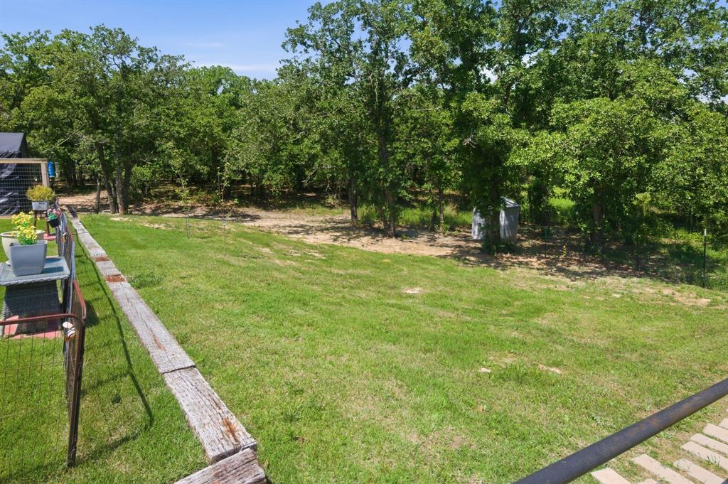 112 Monarch Lane Poolville, TX 76487 - Photo 37 of 37 Expansive green lawn providing a substantial open area