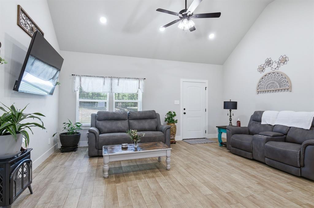 112 Monarch Lane Poolville, TX 76487 - Photo 9 of 37 Living space featuring vaulted ceilings and recessed lighting