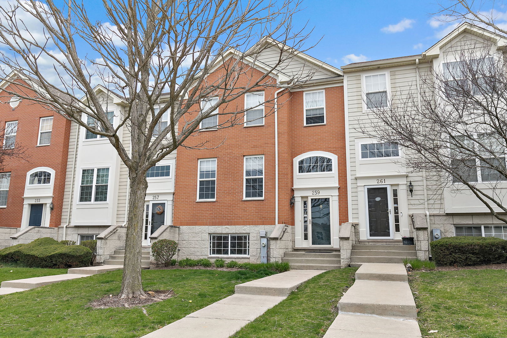 259 Comstock Drive Elgin, IL 60124 - Photo 1 of 15 a front view of a house with a yard