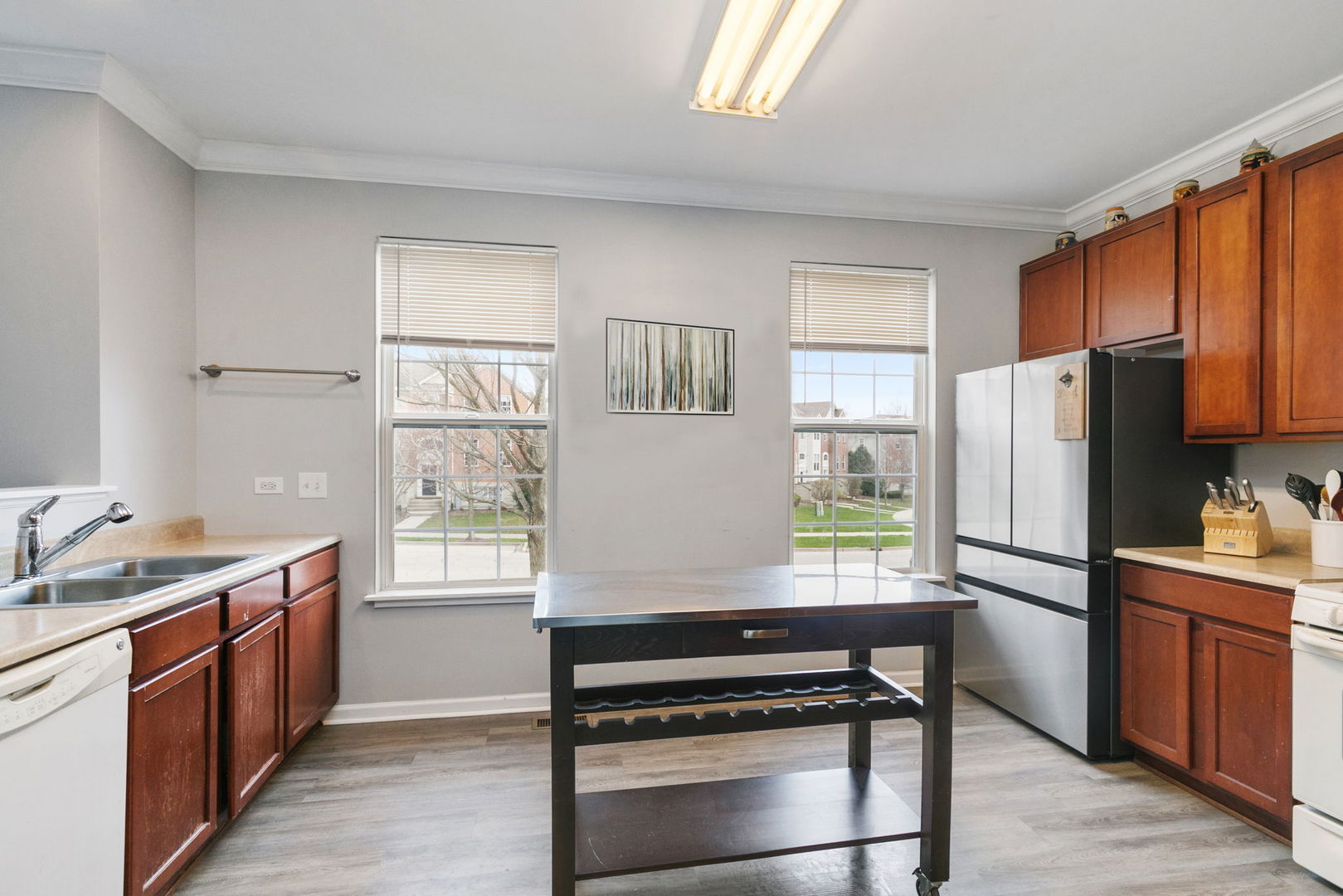 259 Comstock Drive Elgin, IL 60124 - Photo 4 of 15 a kitchen with a refrigerator stove and wooden cabinets