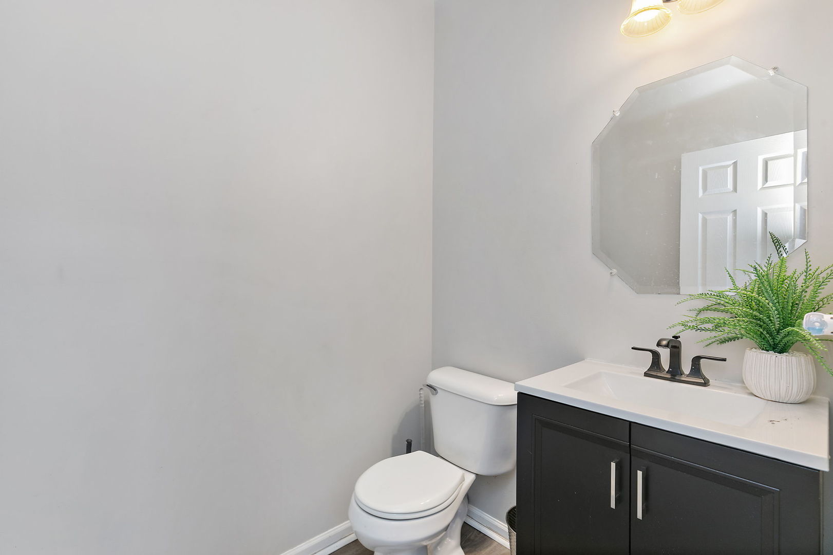 259 Comstock Drive Elgin, IL 60124 - Photo 8 of 15 a bathroom with a sink a toilet and mirror