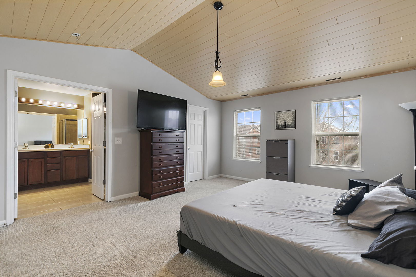 259 Comstock Drive Elgin, IL 60124 - Photo 10 of 15 a spacious bedroom with a bed and a television in it