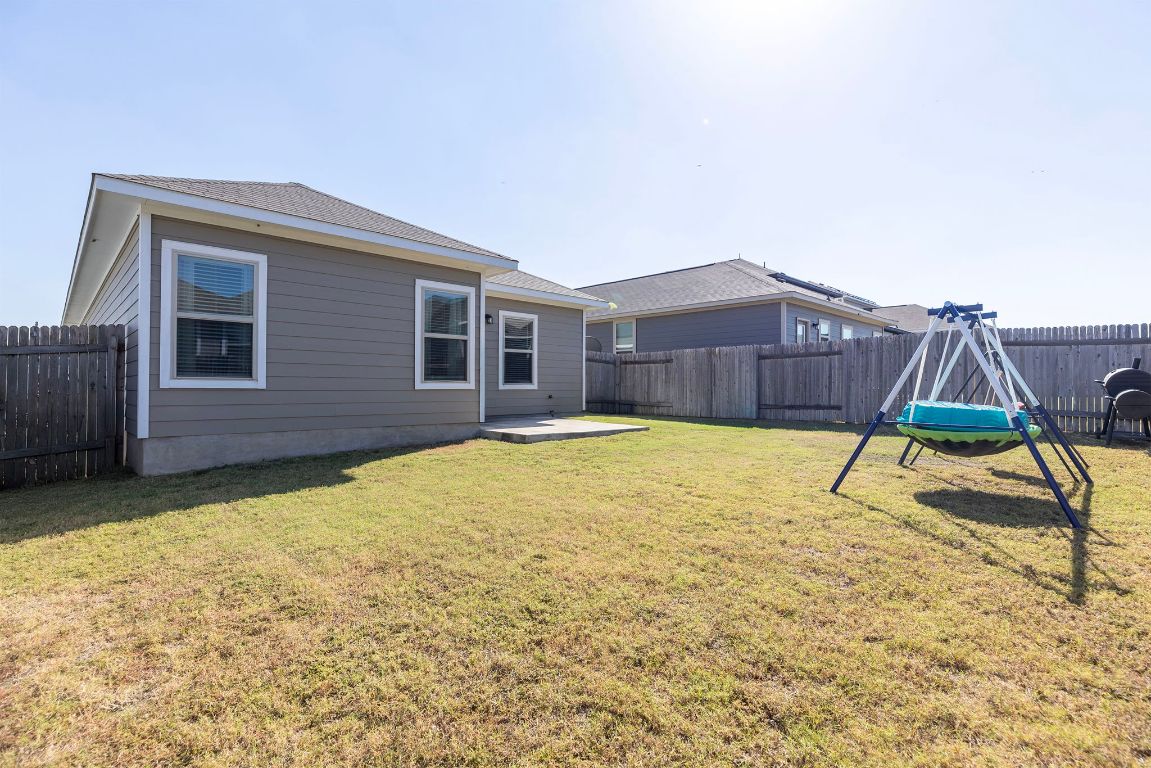 241 El Dorado Road Jarrell, TX 76537 - Photo 24 of 26 a house with a large yard and wooden fence