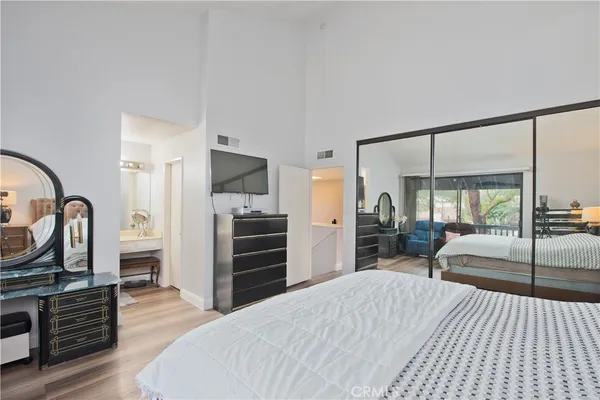 a bedroom with a bed and flat screen tv