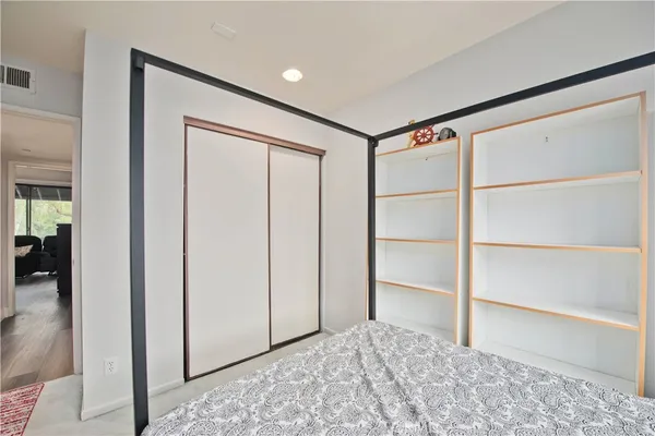 a big room with closet and wooden floor